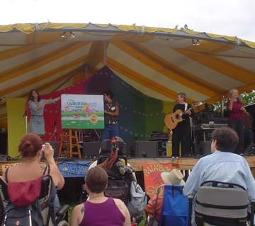 Betsy Franco Feeney turns the pages of the giant book at Clearwater Festival